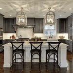 A beautiful kitchen with chairs and lights