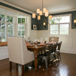 Elegant dining room with a wooden table and mixed seating.